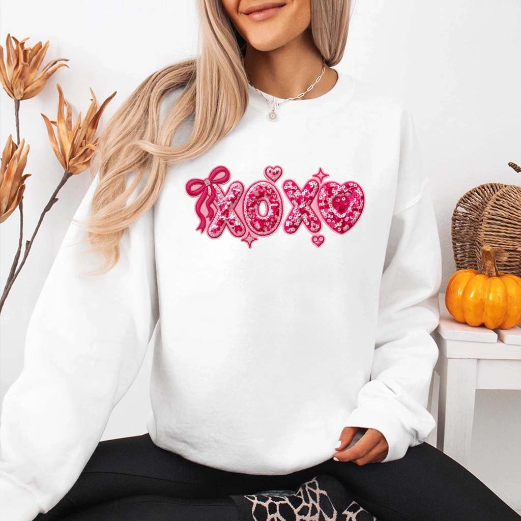 May include a festive “XOXO” design with sparkling sequin-inspired details, decorative lettering, and a glamorous Valentine’s-inspired aesthetic.
